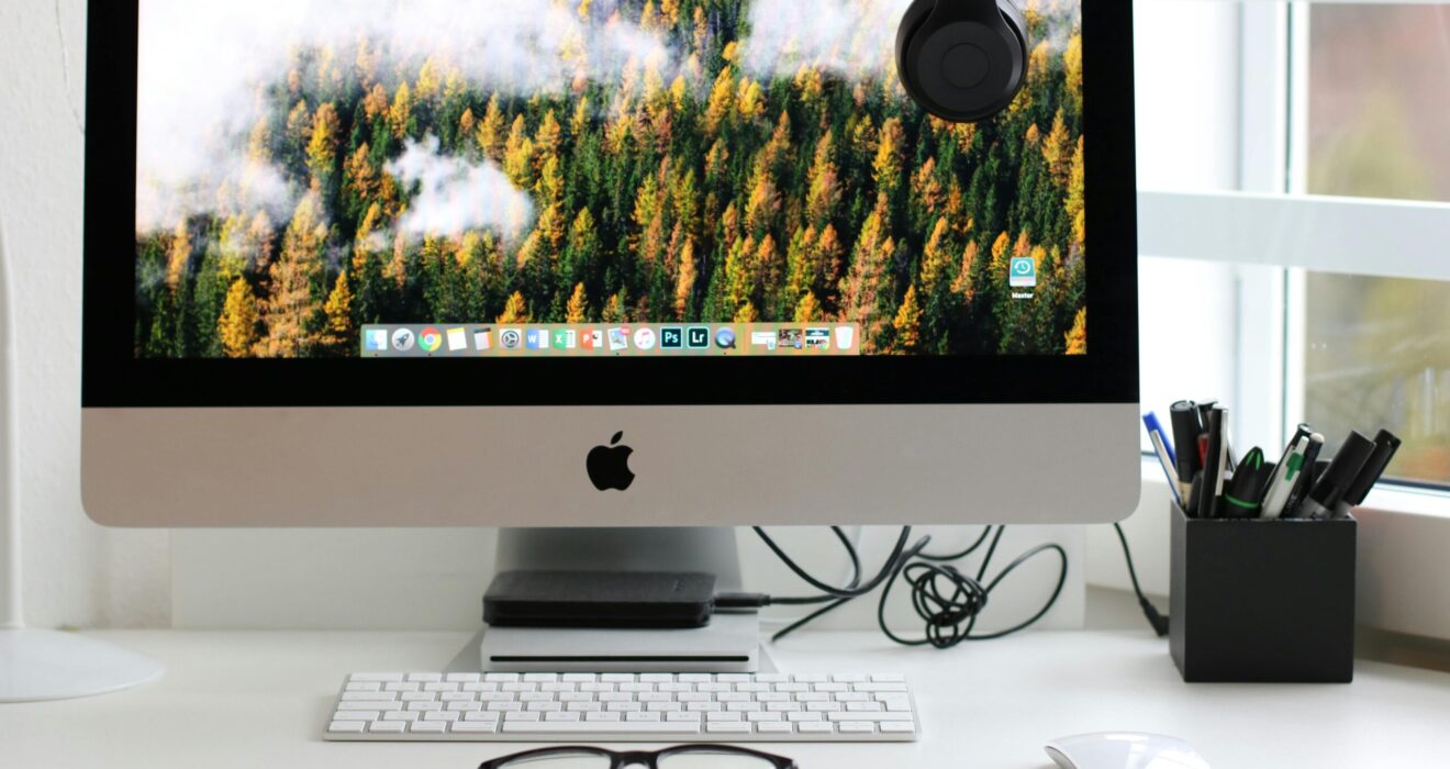 Free Stylish home office workspace featuring a computer setup with accessories. Stock Photo