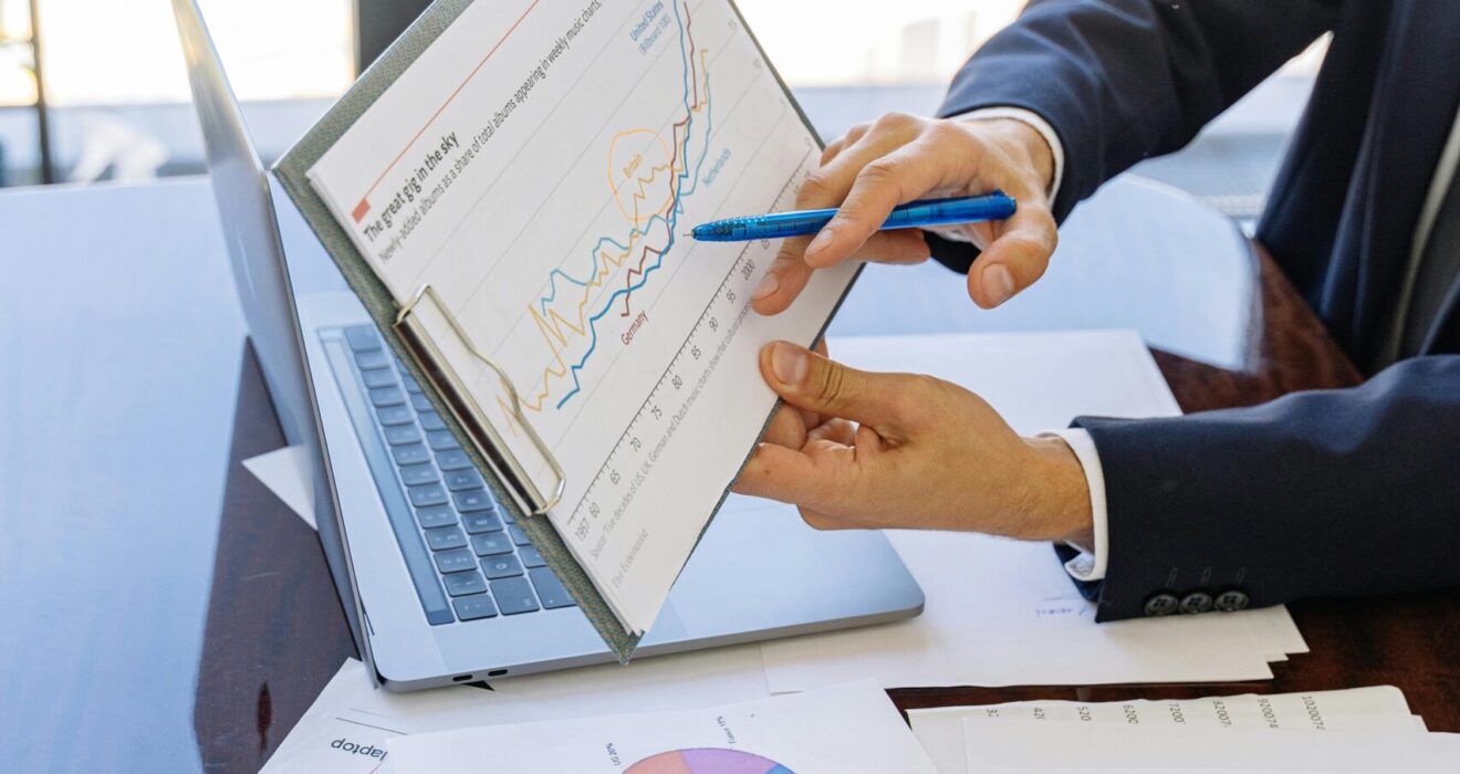 Free Business professionals discussing financial graphs and charts in an office setting. Stock Photo